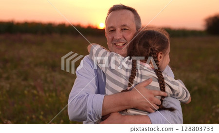 child girl kid childhood outdoors, father man parent male, Father and daughter hug at sunset, Close family bond outdoors, Emotional embrace in nature, Loving father and happy child, Warm sunset in the child girl kid childhood outdoors, father man parent male, Father and daughter hug at sunset, Close family bond outdoors, Emotional embrace in nature, Loving father and happy child, Warm sunset in the 128803733