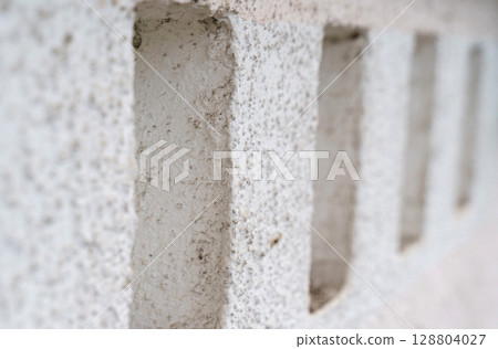Unique texture of a weathered wall showcasing architectural details and depth Unique texture of a weathered wall showcasing architectural details and depth 128804027