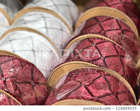 Beautifully crafted textured ribbons in red and silver for festive decor 128804035