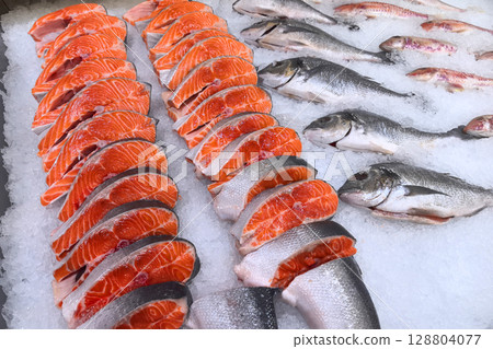 Freshly cut fish displayed on ice at a local market in the early morning 128804077