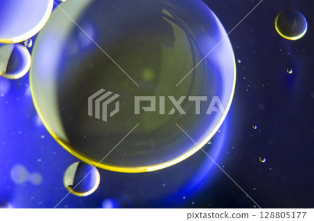Top view of extreme close up of oil bubbles with gradient light yellow background Top view of extreme close up of oil bubbles with gradient light yellow background 128805177