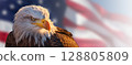 Close-up of an American Bald Eagle Head Over An American Flag Abstract Background Banner - Generative AI. 128805809