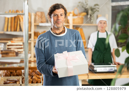 Adult man with box of pastries 128805979