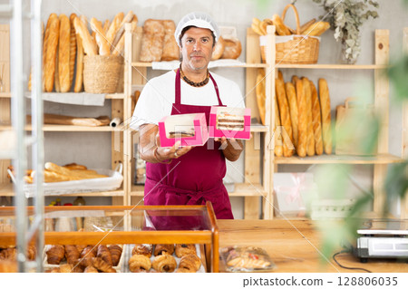 Friendly male baker offers to buy fresh delicious sweet cake 128806035