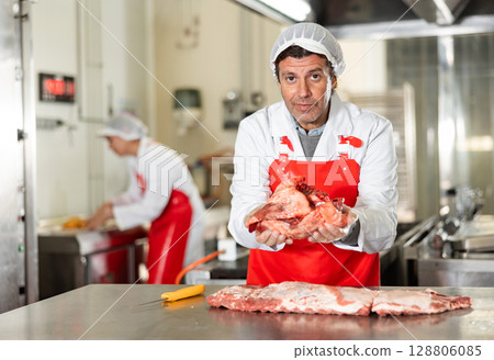 Butchery owner holding fresh raw beef heart in hands 128806085
