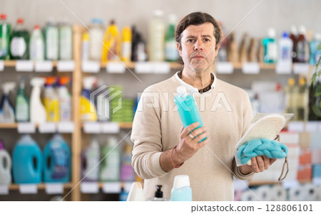 man buys shower gel and washcloths 128806101