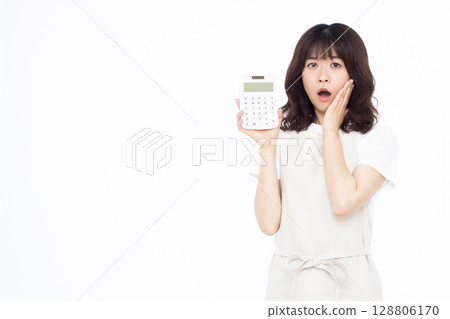 A housewife with a pale face holding a calculator A housewife with a pale face holding a calculator 128806170