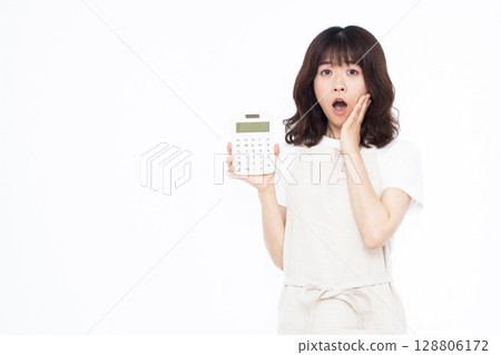 A housewife with a pale face holding a calculator A housewife with a pale face holding a calculator 128806172