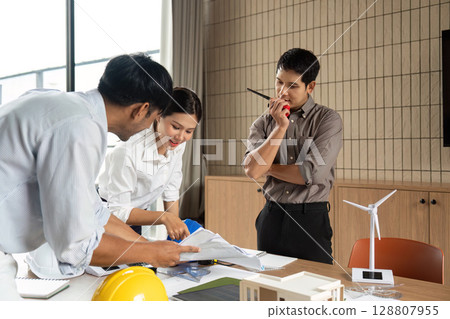 Sustainability in Action: Team Collaborating on Eco-Friendly Project Plans 128807955