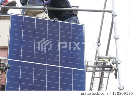 Installation of solar panels on the roof of a house 128809150