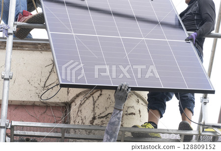 Installation of solar panels on the roof of a house 128809152