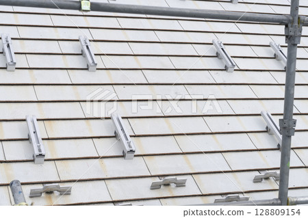 Installation of solar panels on the roof of a house Installation of solar panels on the roof of a house 128809154
