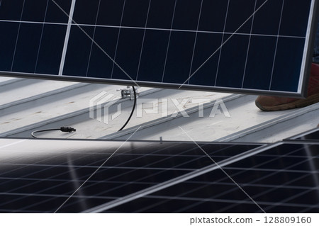 Installation of solar panels on the roof of a house Installation of solar panels on the roof of a house 128809160