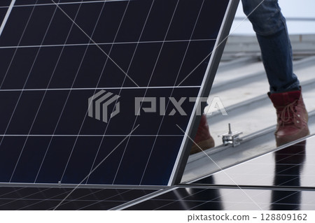 Installation of solar panels on the roof of a house 128809162