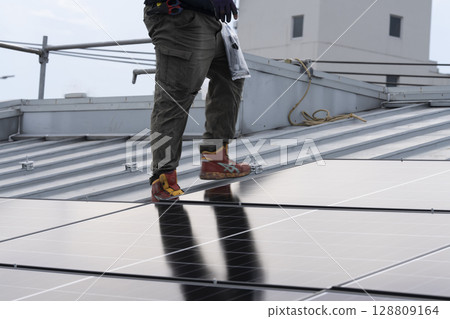 Installation of solar panels on the roof of a house Installation of solar panels on the roof of a house 128809164
