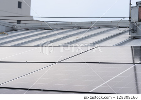 Installation of solar panels on the roof of a house 128809166