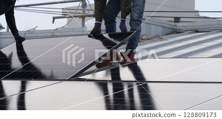 Installation of solar panels on the roof of a house Installation of solar panels on the roof of a house 128809173