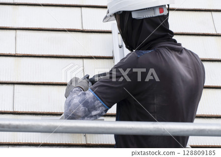 Installation of solar panels on the roof of a house 128809185