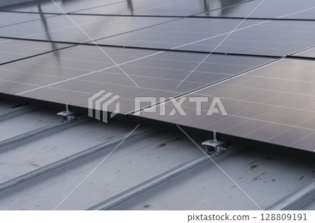 Installation of solar panels on the roof of a house 128809191