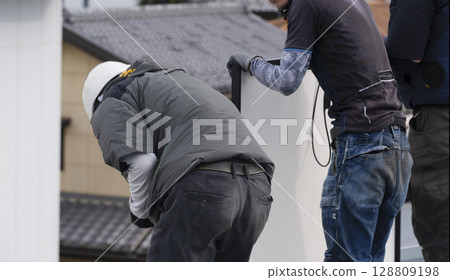 Installation of solar panels on the roof of a house Installation of solar panels on the roof of a house 128809198