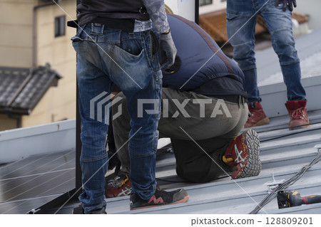 Installation of solar panels on the roof of a house Installation of solar panels on the roof of a house 128809201
