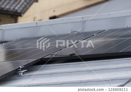 Installation of solar panels on the roof of a house Installation of solar panels on the roof of a house 128809211