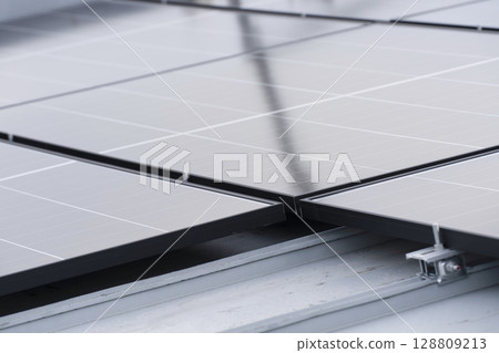 Installation of solar panels on the roof of a house 128809213