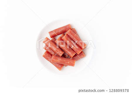 Dry sausage (Kalpas) on a plate on a white background Dry sausage (Kalpas) on a plate on a white background 128809378