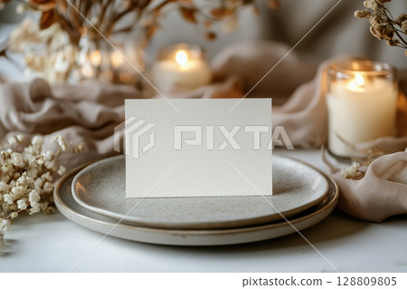 Blank wedding place card on an elegant minimalist table setting Blank wedding place card on an elegant minimalist table setting 128809805