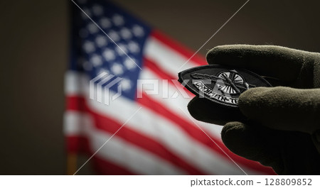 Hand holds military patch, american flag. Gratitude for service. Gratitude, nation honors sacrifice 128809852