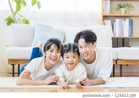 A family relaxing in the living room. 128811189