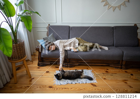 Calm lonely woman rest playing with cat, stroking and sharing fun. Cat therapy in depression 128811214