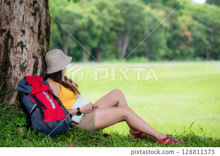 Women hiker or traveler with backpack adventure holding map 128811373