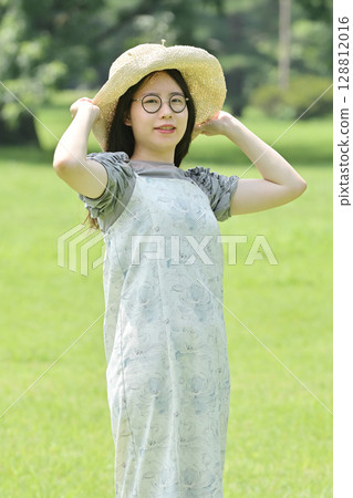 Young woman wearing a bucket hat Young woman wearing a bucket hat 128812016
