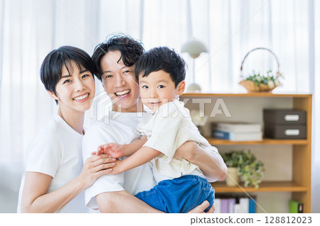A family relaxing in the living room. 128812023