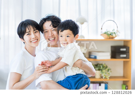 A family relaxing in the living room. A family relaxing in the living room. 128812026