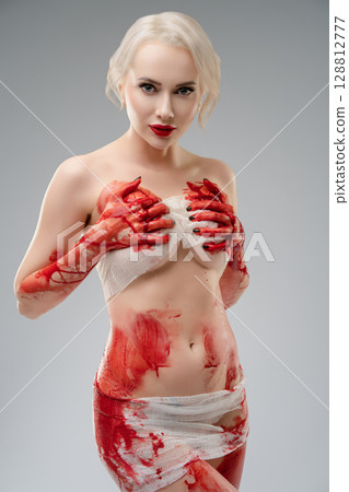 Expression of art through body paint featuring a woman in a studio setting 128812777