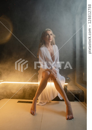 Relaxation and beauty routine of a woman in a sauna with soothing atmosphere 128812788