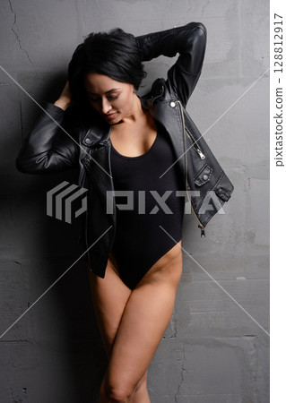Beautiful woman poses confidently in a stylish studio setting Beautiful woman poses confidently in a stylish studio setting 128812917