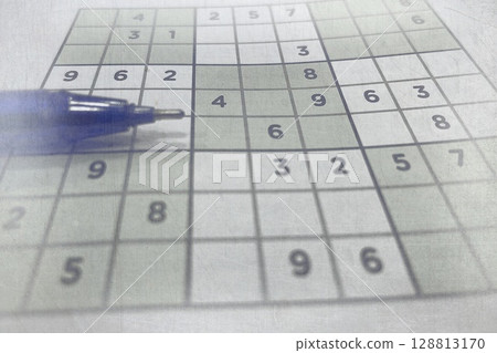 Pen on Partially Solved Sudoku Puzzle. Logic Game for Mental Focus and Brain-Boosting Entertainment 128813170