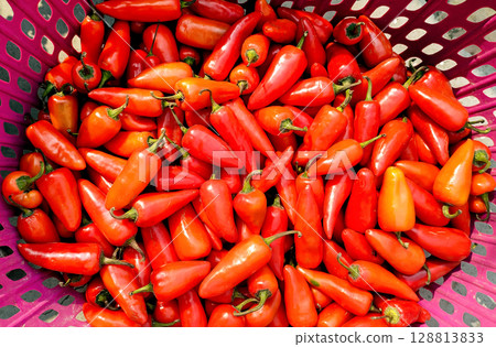 Fresh Red Chili Peppers in a Basket 128813833