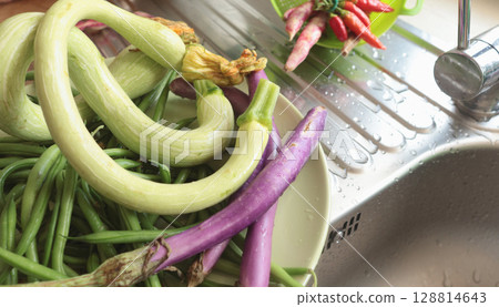 Unusually shaped vegetables on plate. Zucchini and eggplant, asparagus beans and peppers. Seasonal food and farm organic produce. 128814643