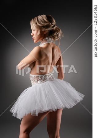 Elegant woman dances in lingerie in a professional studio setting 128814662