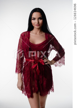 Elegant woman posing in red lingerie in a bright studio environment 128814696