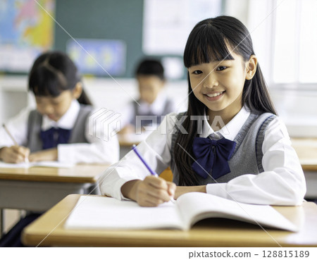 Smiling elementary school student studying positively | Girl studying in the classroom 128815189