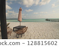 Empty wicker chairs beach umbrella facing the serene ocean on the island of Koh Rong Sanloem, Sihanoukville, Cambodia 128815602