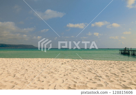 A peaceful sandy beach with clear skies and turquoise waters, offering a tranquil atmosphere in Koh Rong Sanloem, Sihanoukville, Cambodia A peaceful sandy beach with clear skies and turquoise waters, offering a tranquil atmosphere in Koh Rong Sanloem, Sihanoukville, Cambodia 128815606