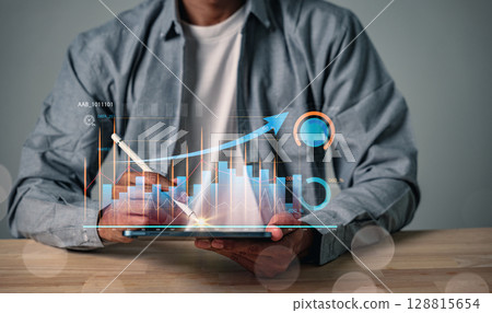 Analyzing digital data, business strategy and market growth using a tablet, businessman develops a growing virtual hologram graph for a solid business performance and corporate digital marketing plan Analyzing digital data, business strategy and market growth using a tablet, businessman develops a growing virtual hologram graph for a solid business performance and corporate digital marketing plan 128815654