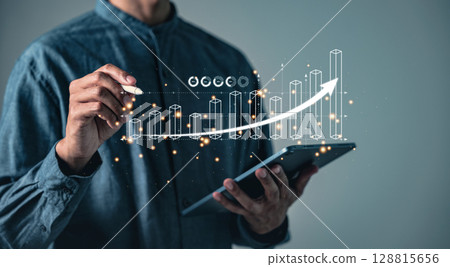 A person uses a pen to interact with a bar graph and a rising arrow on a digital tablet, displaying A person uses a pen to interact with a bar graph and a rising arrow on a digital tablet, displaying 128815656