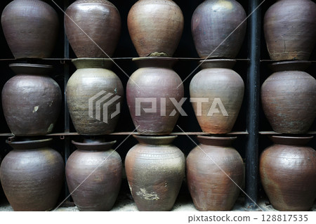 Pottery clay jars on a rack Pottery clay jars on a rack 128817535